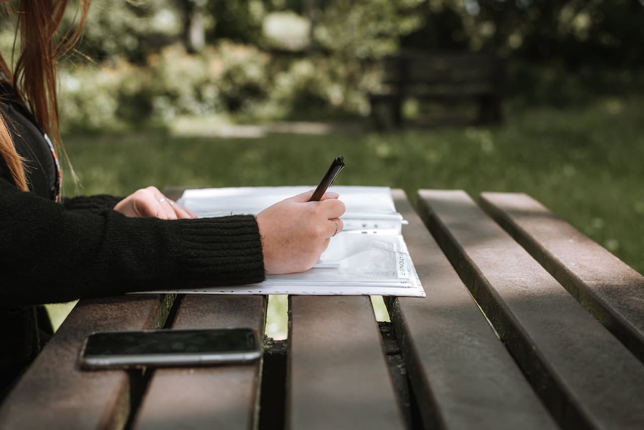 woman writing at the park